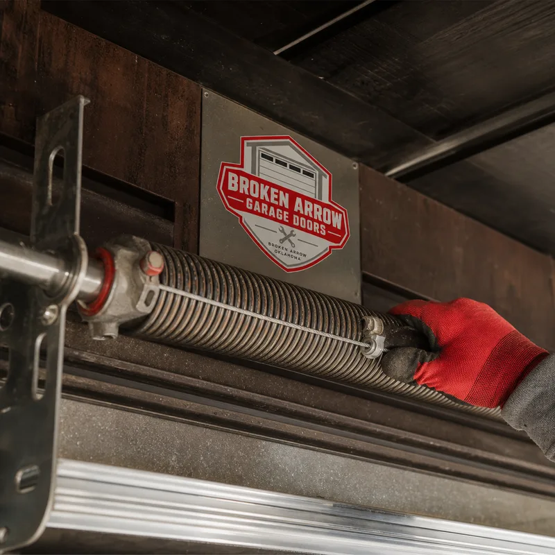 Extension spring system along a horizontal track with a safety cable routed through the spring